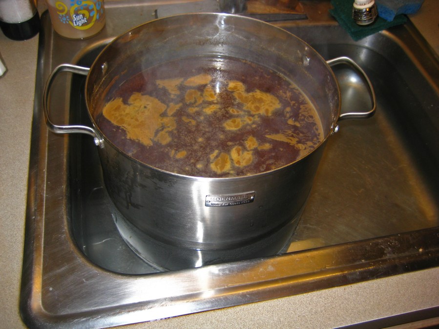 Brew pot being cooled with cold water.