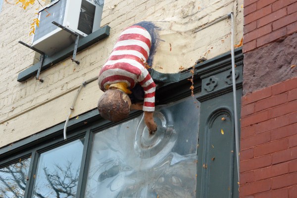 It appears to be a boy dipping his finger in a pond.